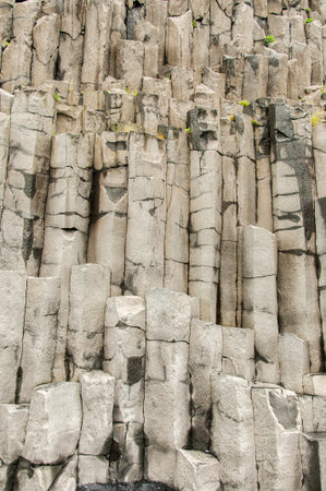 Reynisfjara beach, detail of escarpment with numerous basalt columns in Icelandの写真素材