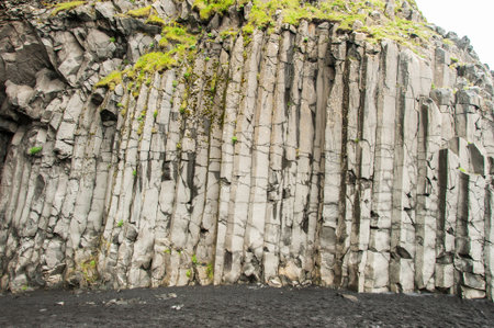 Reynisfjara beach, detail of escarpment with numerous basalt columns in Icelandの写真素材