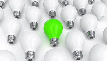 Green and white light bulbs on white background. Technology and ecology conceptの素材
