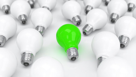 Green and white light bulbs on white background. Technology and ecology conceptの素材