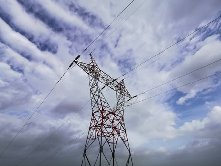 Electricity pylon against the blue sky, closeup of photoの写真素材