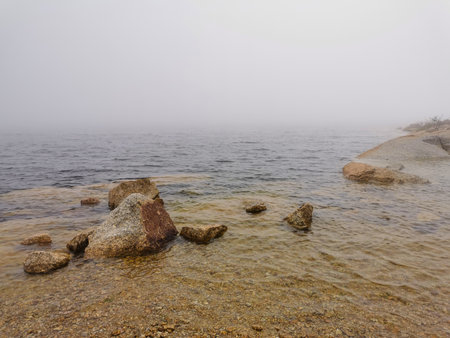 Idyllic landscape of a lagoon in a foggy environment, in Lagoa Comprida, Serra da Estrela, Portugalの写真素材