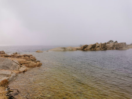 Idyllic landscape of a lagoon in a foggy environment, in Lagoa Comprida, Serra da Estrela, Portugalの写真素材