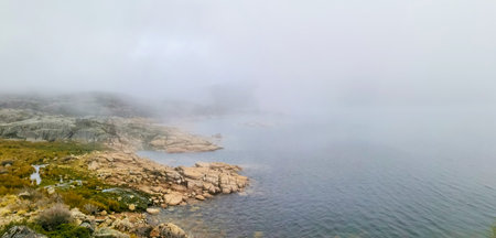Idyllic landscape of a lagoon in a foggy environment, in Lagoa Comprida, Serra da Estrela, Portugalの写真素材