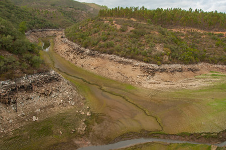 The Ponsul River is a affluent of the Tejo River, in Portugal, and is a very large river. At this time it is completely dry, without water and with its bed cracked. Climate changeの写真素材