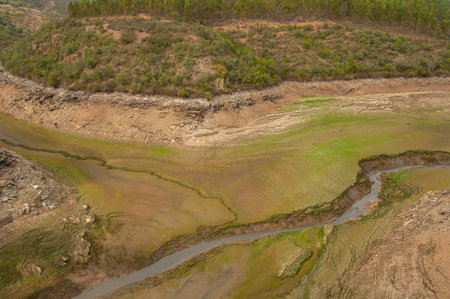 The Ponsul River is a affluent of the Tejo River, in Portugal, and is a very large river. At this time it is completely dry, without water and with its bed cracked. Climate changeの写真素材