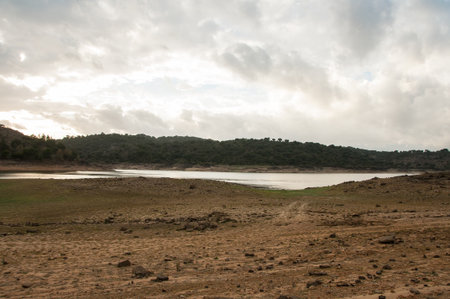 Dam bed on the Tejo river, in Portugal, without water. It is possible to walk where there should be many cubic meters of waterの写真素材