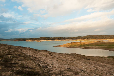 Dam bed on the Tejo river, in Portugal, without water. It is possible to walk where there should be many cubic meters of waterの写真素材