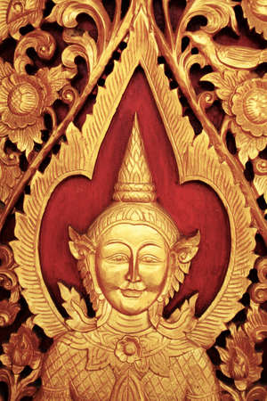 Door wood carving in thai templeの写真素材