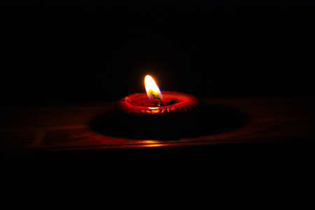 Candle fire on a black background. の写真素材
