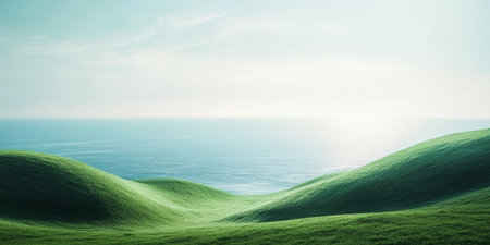 This serene and picturesque landscape features gently rolling hills, vibrant green grass, and a calm ocean that sparkles beautifully at sunrise, making it an ideal spot for peaceful reflectionの素材