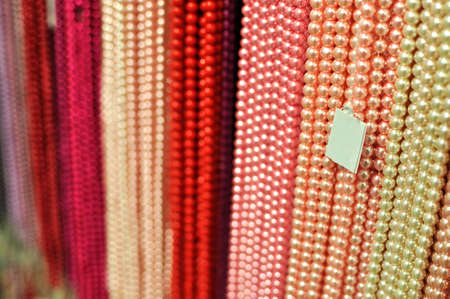 Vivid color of beads strings hanging in rows at the jewelry store.の写真素材