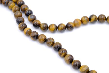tiger eye stone beads isolated on white backgroundの写真素材