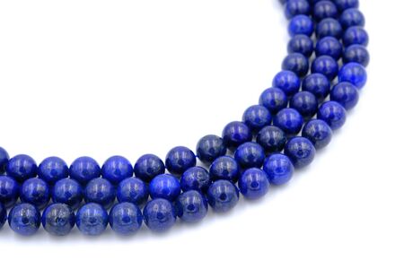 Blue lapis lazuli natural stone round shape bead isolated on white backgroundの写真素材