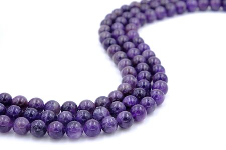 Purple amethyst natural stone round shape bead isolated on white backgroundの写真素材