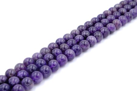 Purple amethyst natural stone round shape bead isolated on white backgroundの写真素材