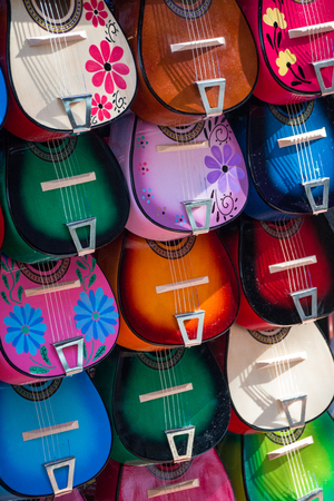 Colorful Ukuleles presented for sale on a marketの写真素材