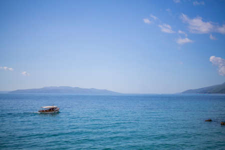 Photo of the Sea view and a boat with waves with relaxationの写真素材