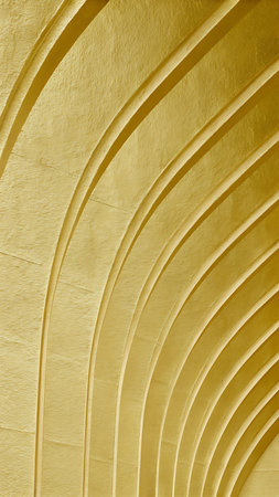 Golden foil surface featuring arched metallic ridges and soft texture ideal for premium luxury design backgroundsの素材