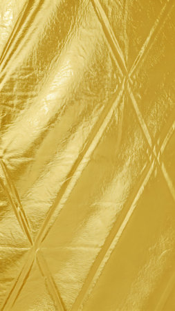 Close up of a golden textured surface with a diamond pattern and shiny appearanceの素材
