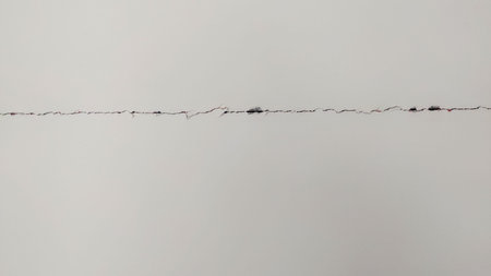 Cracked wall surface showing visible line due to poor construction and weak plaster work on white wallの写真素材