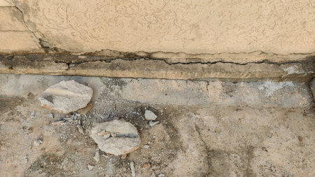 Cracked rough surface between wall and floor showing aged texture detail symbolizing imperfection...