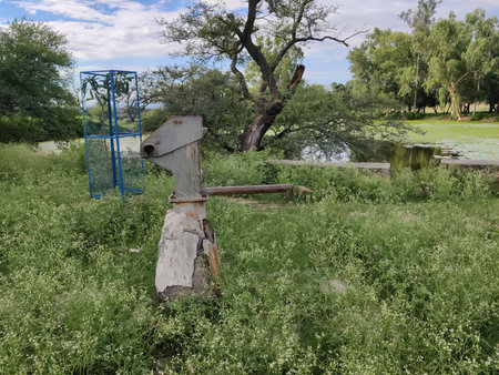 Vintage Hand Operated Water Pump from Historic Era in Rural Pakistan Symbolizing Traditional Water...
