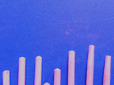 Mini Wooden Sticks Arranged on Blue Background â€“ Craft Material Flat Lay