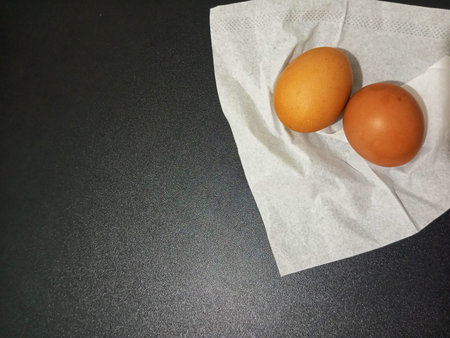 Top View Chicken Eggs in Upper Right Corner on Black Background