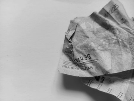 Close up of wrinkled paper money placed on the right side of a white background. Financial concept...
