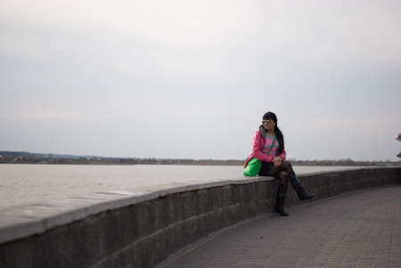 girl looking to the riverの写真素材