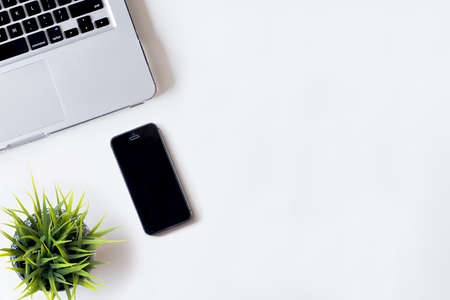 White office desk table with laptop, smartphone, and plant. Top view with copy space, flat lay, 2017の写真素材