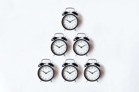 White office desk table with alarm clock. Top view with copy space, flat lay.の写真素材
