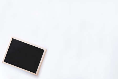 White office desk table with chalkboard. Top view with copy space, flat lay.の写真素材