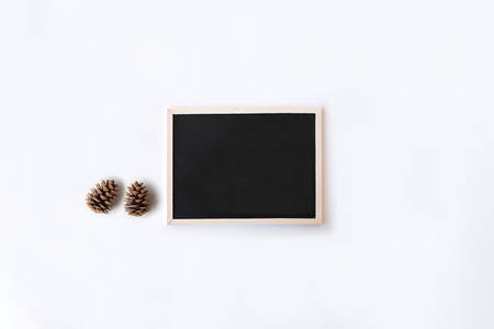 White office desk table with chalkboard and pinecones. Top view with copy space, flat lay.の写真素材