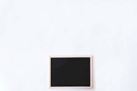 White office desk table with chalkboard. Top view with copy space, flat lay.の写真素材