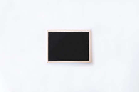White office desk table with chalkboard. Top view with copy space, flat lay.の写真素材
