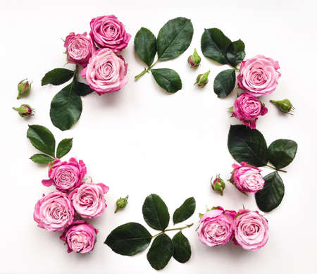 Decorative frame with pink bright roses and leaves on white background. Flat layの写真素材