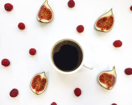 Bright morning cup of coffee with fig fruits and raspberries. Autumn concept, orange and red. Flat lay, top view, view from aboveの写真素材