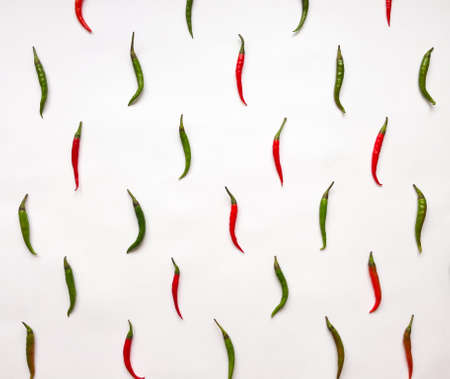 Bright pattern with red and green chili peppers on white background. Flat lay, top view, view from aboveの写真素材