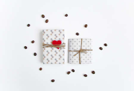 Handmade gifts on white background decorated with heart and coffee beans. Rustic style, cute paper DIY decoration. Valentine's day or other holiday concept. Flat lay, top viewの写真素材