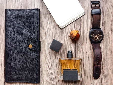 Closeup of men's accessories and essential items on wooden background. Decorated with autumn chestnut. Flat lay, top view, view from aboveの写真素材