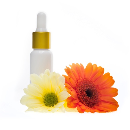 Natural body-care cosmetic product on a white background with an orange and a yellow flowersの写真素材