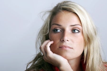 Portrait of a pensive beautiful young blond woman looking awayの写真素材