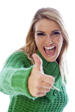 Blond girl in green sweater with thumbs up signの写真素材