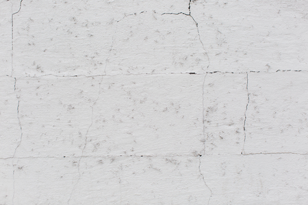 Weathered grungy wall texture with mold spots from damp, cracked off-white paint and discoloration in a full frame background for copyspaceの写真素材