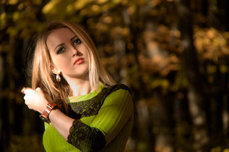 Pretty girl in autumn forestの写真素材