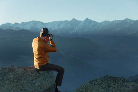 Travel photographer shoots mountains. Photographing the landscape.の写真素材