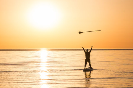 A man is having fun in the sea on a SUP-board.