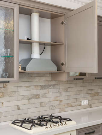 Cooking gas stove with hood in modern kitchen.の写真素材